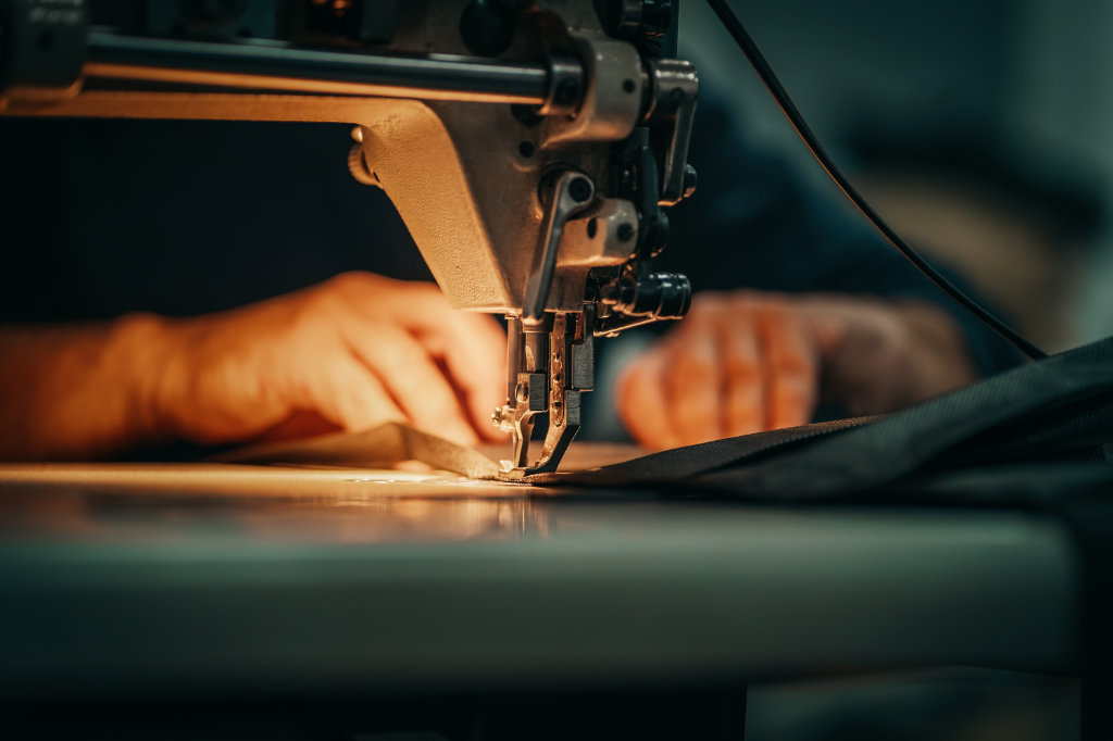 Sewing machine and men’s hands of a tailor